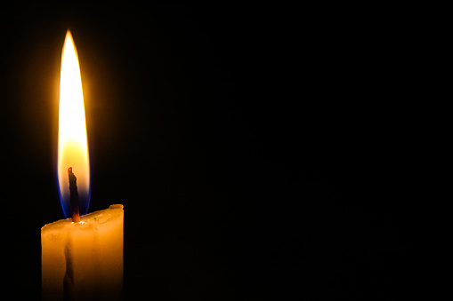 a burning candle with negative space
