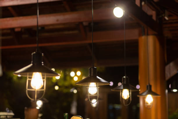 istock Several vintage yellow pendant lights provide light at night. 1613306078