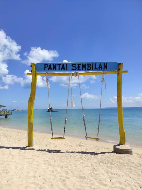 istock A swing with the words Pantai Sembilan or Sembilan Beach written on it. 1613315070