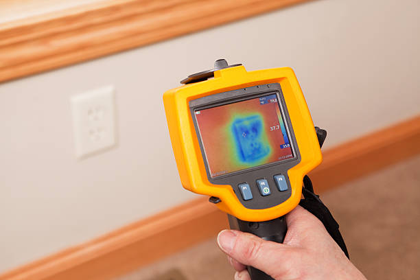 istock Infrared Thermal Imaging Camera Pointing to Wall Outlet 161332982