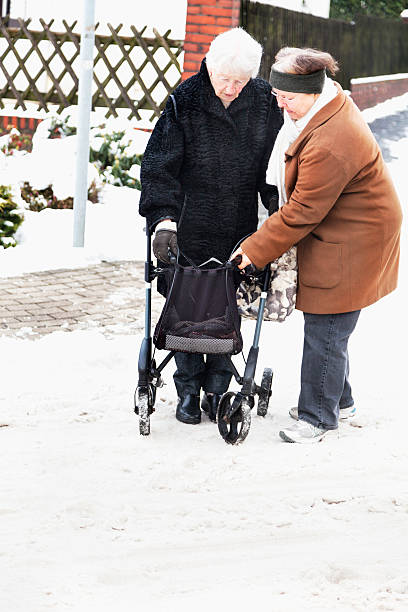 istock danger senior woman with walker on snow 161333003