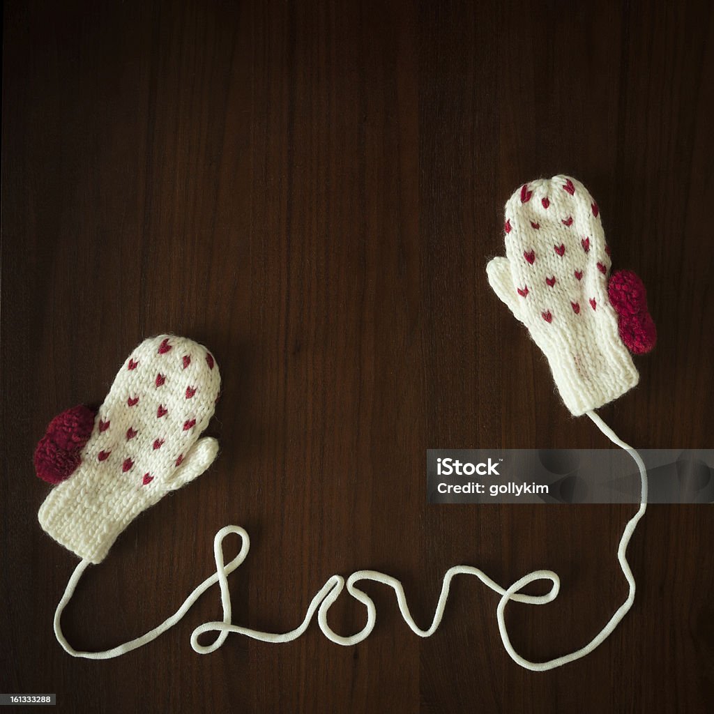 You are my warm gloves Handcrafted love mittens against wood background Winter Stock Photo