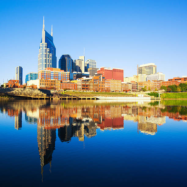 Nashville Skyline reflected in the Cumberland River View of Downtown Nashville during a beautiful early morning. nashville skyline stock pictures, royalty-free photos & images