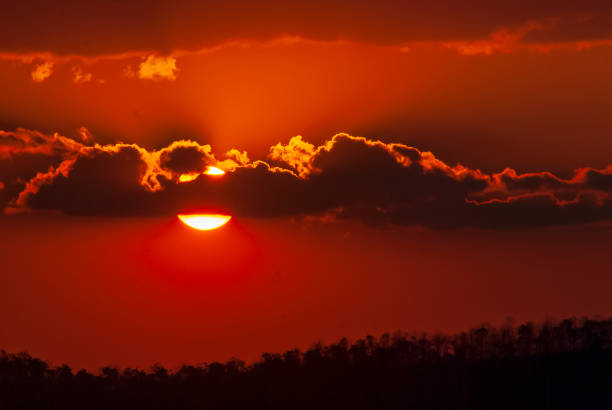 istock Scenic view dramatic beautiful sunset sky. Natural Sunset Sunrise on meadow silhouette shadow dark land. Vibrant dramatic sky on sunset, dawn, sunrise in Countryside. Landscape Colorful Sky At Sunset 1613345639