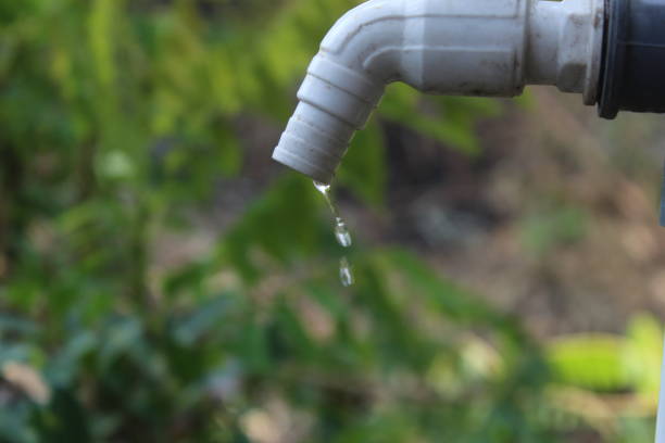 istock water faucet dripping water with blurred background, 1613345655