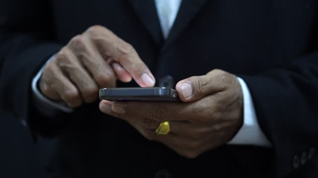 Businessmen use mobile phones to communicate online
