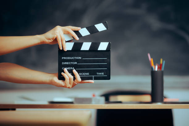istock Hands Holding a Film Slate in a School Classroom 1613346869