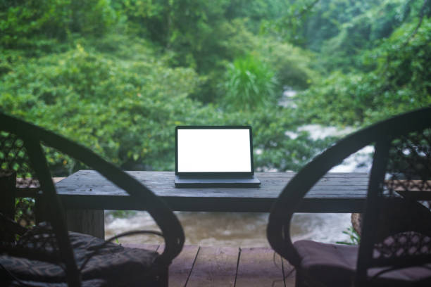 istock Laptop computer on the balcony by the water, relaxing work 1613346889