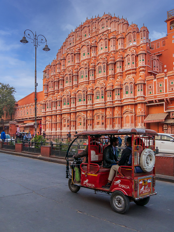 Jaipur, India - December 20, 2022: Tuk Tuk the most common transport of Jaipur near Hawa Mahal, one of the popular tourist destination
