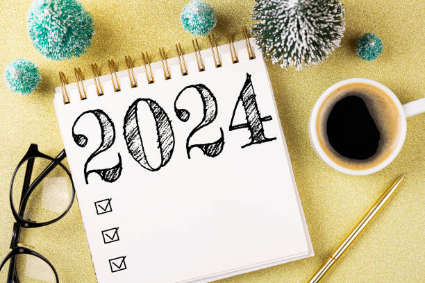 istock New year resolutions 2024 on desk. 2024 resolutions list with notebook, coffee cup, decorations on table. Goals, resolutions, plan, action concept. New Year 2024 template 1613398688