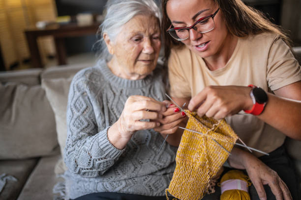 istock grandmother teaching granddaughter knitting 1613452350