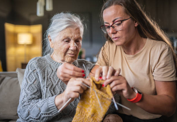 istock grandmother teaching granddaughter knitting 1613452353