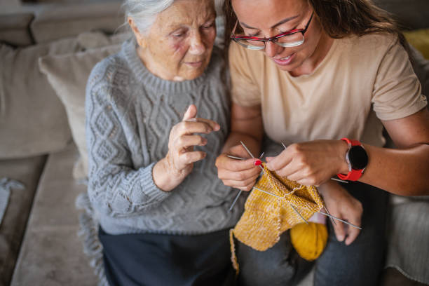 istock grandmother teaching granddaughter knitting 1613452359