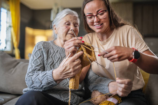 istock grandmother teaching granddaughter knitting 1613452362