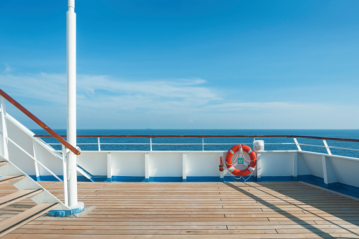 Ship deck, buoy and blue ocean. Travel background