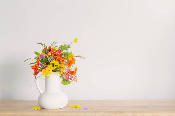 istock summer flowers in white jug on wooden table 1613463381