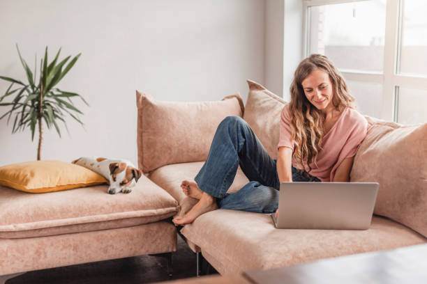 istock Cheerful woman using silver laptop 1613512961