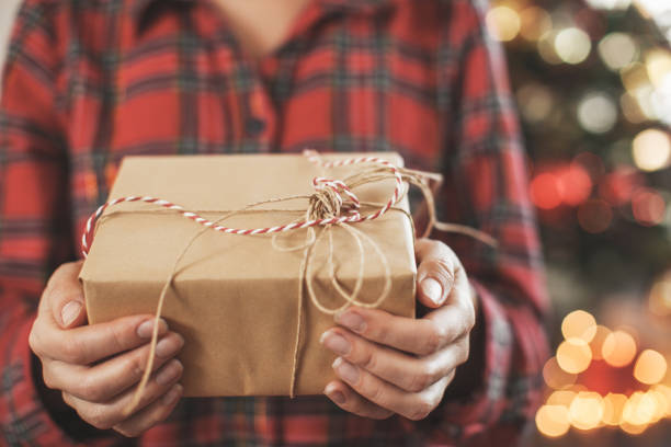 istock Christmas gift on female hands 1613523741