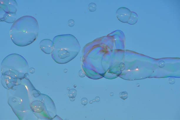 istock Scenery of soap bubbles dancing in the blue sky. 1613564853