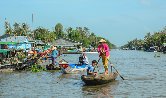 Soc Trang, Vietnam - Feb 2, 2016. People with boats a floating market on Mekong River in Soc Trang, Vietnam. Mekong is the longest river in Southeast Asia, the 7th longest in Asia.