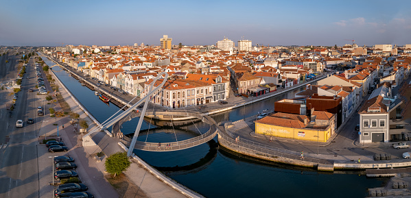 flying with a drone over the canals of aveiro passing by the bridges