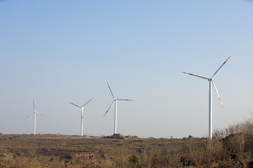 Wind turbines or windmill farm generating electricity indian india, Concept of Clean and green energy.Background.