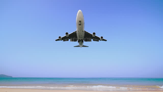 Air plane landing over the beach