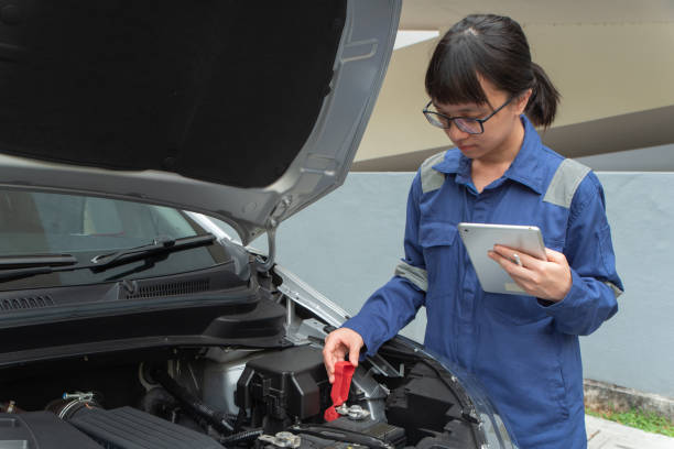 istock Asian lady carry out car maintenance 1613609139