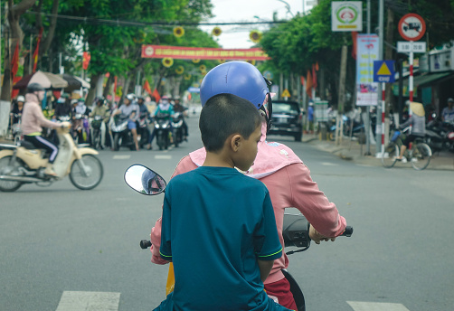 Long Xuyen, Vietnam - Sep 1, 2017. People riding motorbike on busy street in Long Xuyen, Vietnam. Long Xuyen is the provincial city and capital city of An Giang Province.