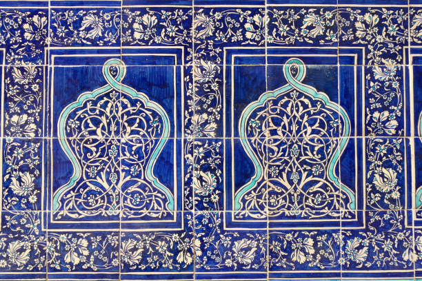 istock The wall covered with blue floral tiles 1613615296