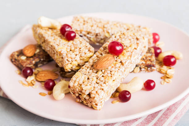 istock Various granola bars on table background. Cereal granola bars. Superfood breakfast bars with oats, nuts and berries, close up. Superfood concept 1613631794