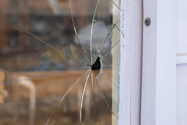 istock bullet hole in house window, old hole with cracks, shattered glass 1613644911