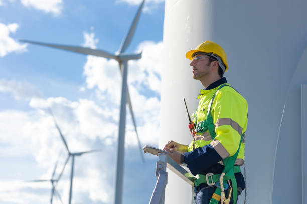 istock Smart confident engineer male Wind Turbines service team standing looking sky forward for the future of clean energy concept 1613647727