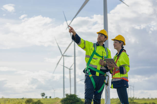 istock Engineer team man and woman field working together survey plan construction wind turbine clean power generator 1613647729