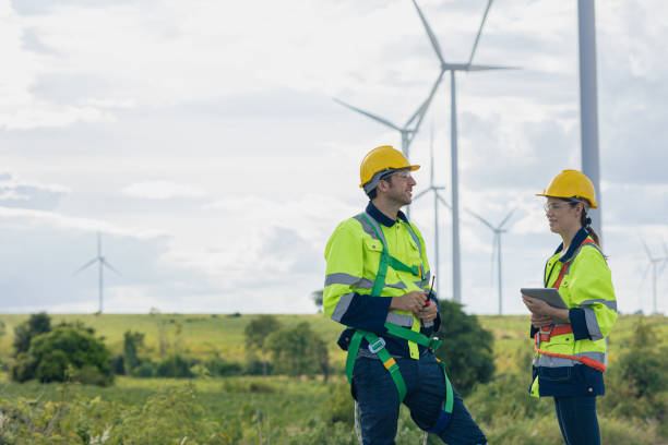istock Engineer team man and woman field working together survey plan construction wind turbine clean power generator 1613647738