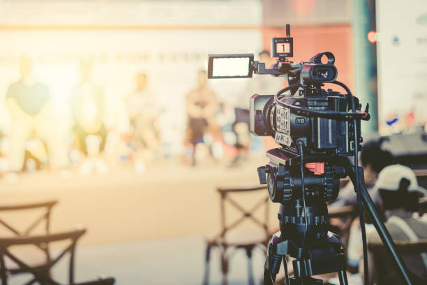 istock camcorder in press conference seminar on stage record event. video camera live media  broadcast realtime streaming vintage color tone 1613648273