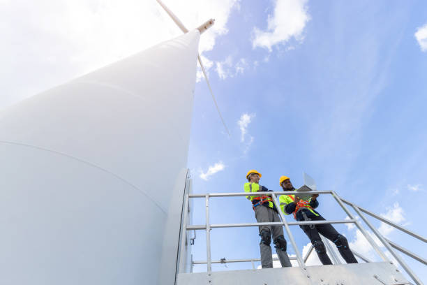 istock Wind turbine engineer technician male team working service maintenance survey construction site. Eco power energy generator for sustainable people worker. 1613648313