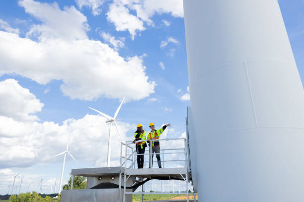 istock Wind turbine engineer technician male team working service maintenance survey construction site. Eco power energy generator for sustainable people worker. 1613648828