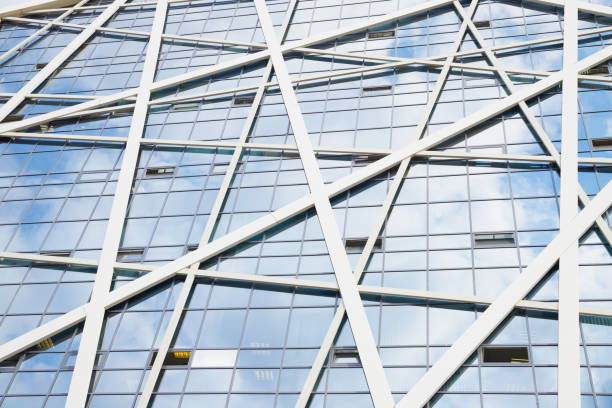 istock glass modern skyscraper building facade full frame, windows, diagonal construction. futuristic background texture, view from below 1613649896