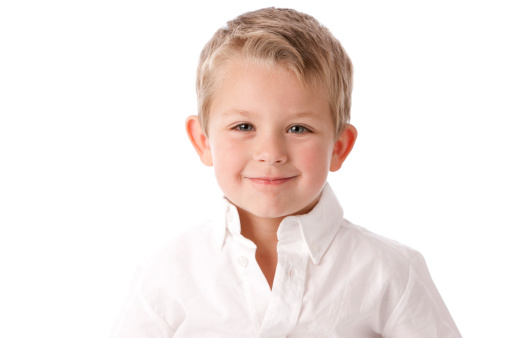 A head and shoulders image of an adorable caucasian little real boy with a big smile on his face.