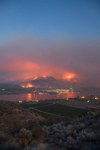 オッソヨス湖近くの山火事によって引き起こされた燃えるオレンジと黄色の空、ブリティッシュコロンビア州、カナダ - lake osoyoos ストックフォトと画像