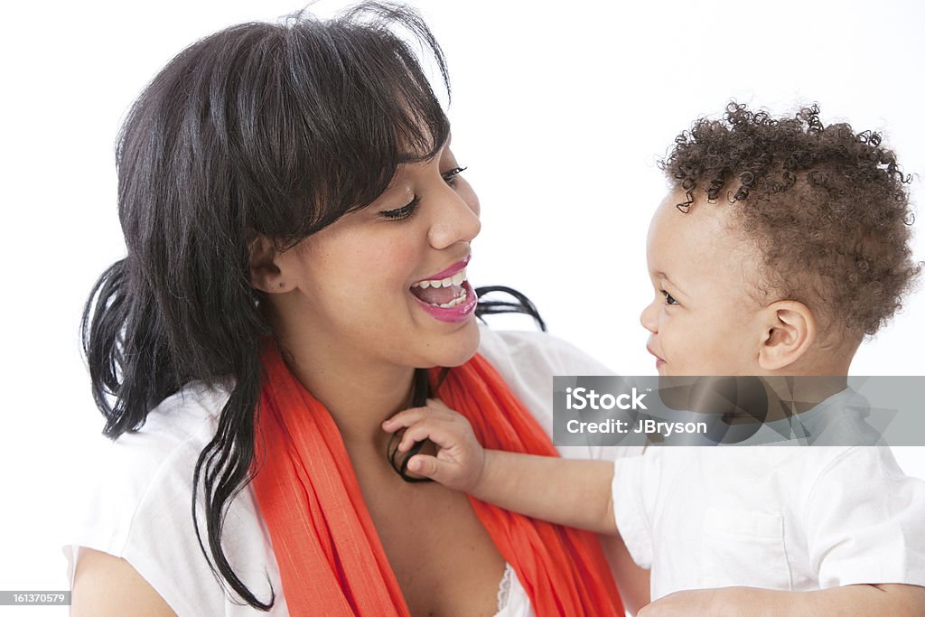 Real People: Black African American Mother Talking with Toddler A head and shoulders image of a Black / African American mother holding and talking to her toddler little boy. Talking Stock Photo