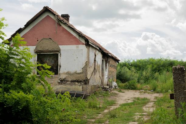 istock Isolated abandoned house situated in a grassy area during cloudy weather 1613709908