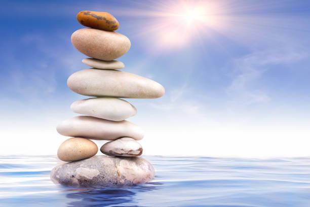 istock Zen stones balanced in water with sunlight 1613716229