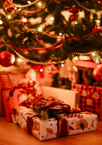 istock Beautiful Christmas gift boxes and presents under the Christmas tree 1613721038