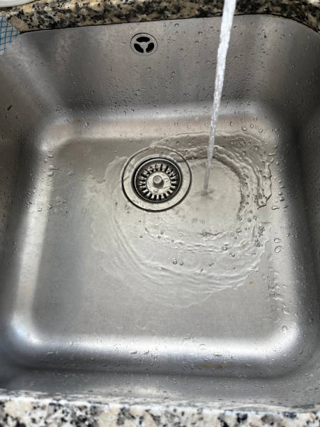 istock Water running in stainless steel sink 1613721581