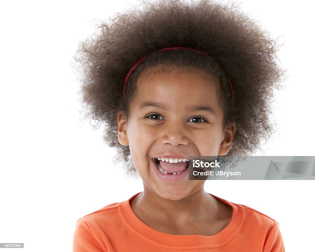 Laughing African American Little Girl Closeup Headshot An ethnic (African American) little girl has a big smile on her face and is laughing. Child Stock Photo