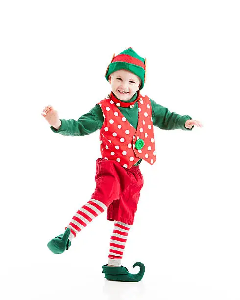* Motion Blur. A happy, joyful, smiling boy, dressed as a Christmas elf, dances a gleeful jig. 