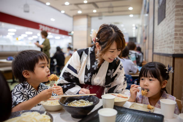 family eating fried udon noddle in food court - camel fair imagens e fotografias de stock