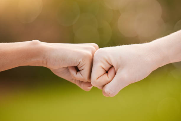 istock Hands, fist bump and teamwork, support or collaboration for team building, solidarity or unity. Hand connection, partnership or greeting, thank you or motivation for success, goal or targets outdoors 1613740900